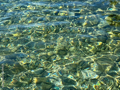 Pebbles stones in transparent sea water. 
