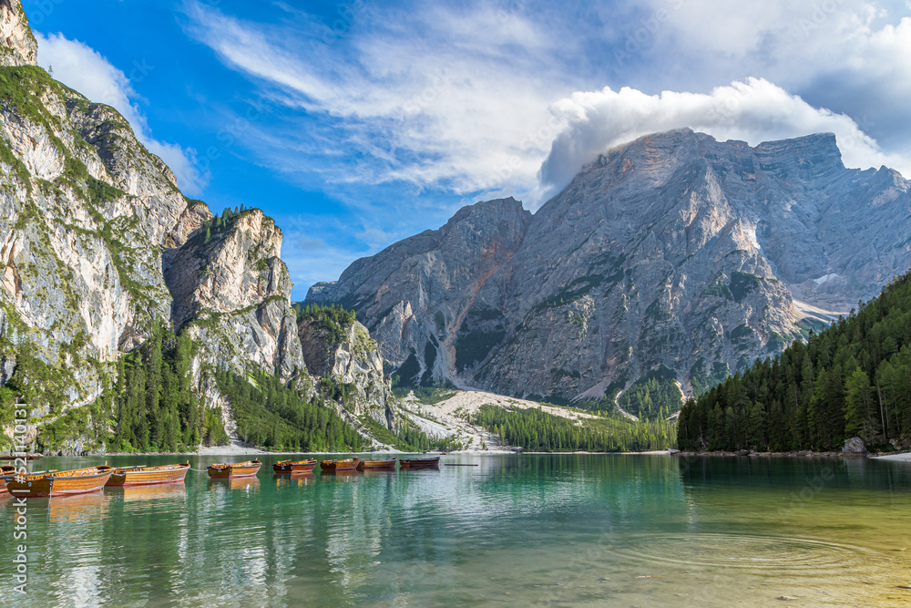 Braies Lake, Italy. Group of the traditional rowing boats. Alpine lake. Picturesque mountain lake in Dolomites. Wonderful nature contest