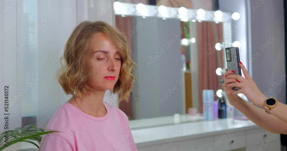 Hairstylist is making photo client in salon for portfolio Hairstylist is making photo client in salon for portfolio
