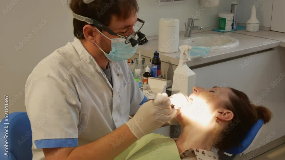 Dental clinic. The doctor prosthetics the teeth of an adult woman. Dental clinic. The doctor prosthetics the teeth of an adult woman.