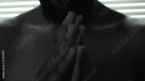 Afro Black Man praying and believe in a new religion. extreme close shot photo