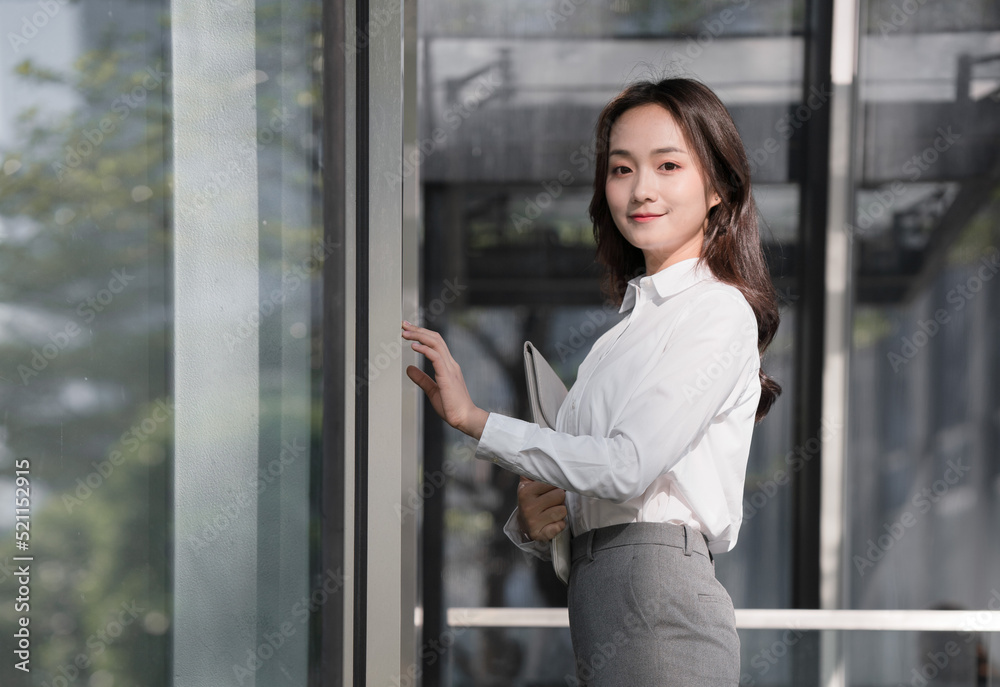 Business woman holding laptop and pressing elevator button Business woman holding laptop and pressing elevator button