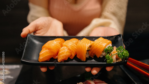 Sashimi, Salmon, Japanese food chopsticks and wasabi on the blacktable. photo