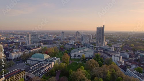 Aerial view of Essen city in Germany with reddish sky. Sudviertel district in Essen, Germany. panoramic landscape of Europe from above. The city skyline under the sunset.