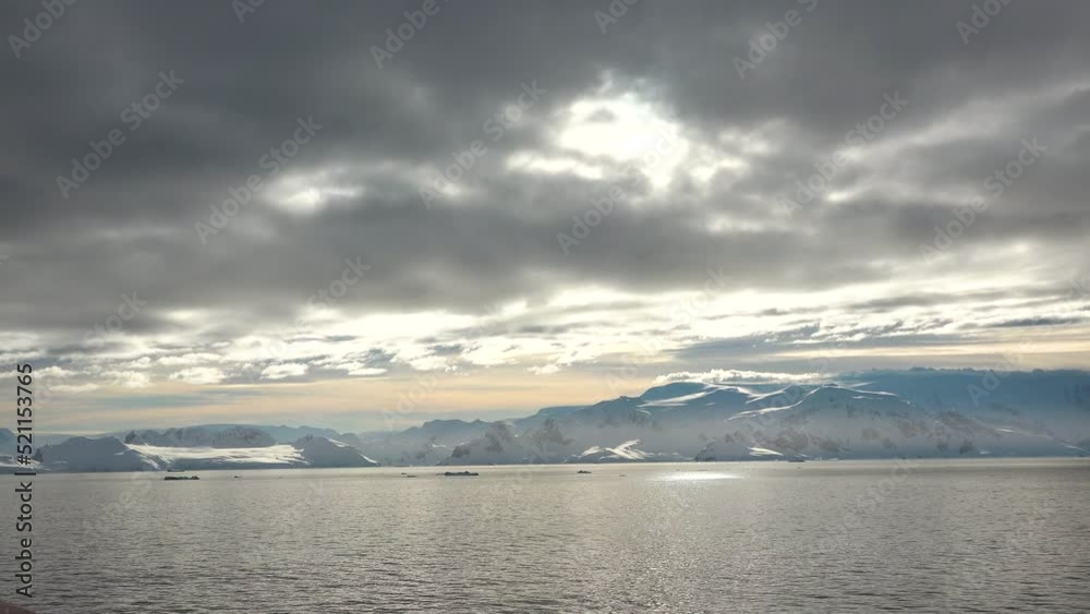 Go Everywhere. Colorful Mountains at Sunset in Antarctica. Mirror reflection in Ocean Water. Majestic winter landscape. Beauty world, holidays, sports and recreation. Travel background. Go Everywhere. Colorful Mountains at Sunset in Antarctica. Mirror reflection in Ocean Water. Majestic winter landscape. Beauty world, holidays, sports and recreation. Travel background.