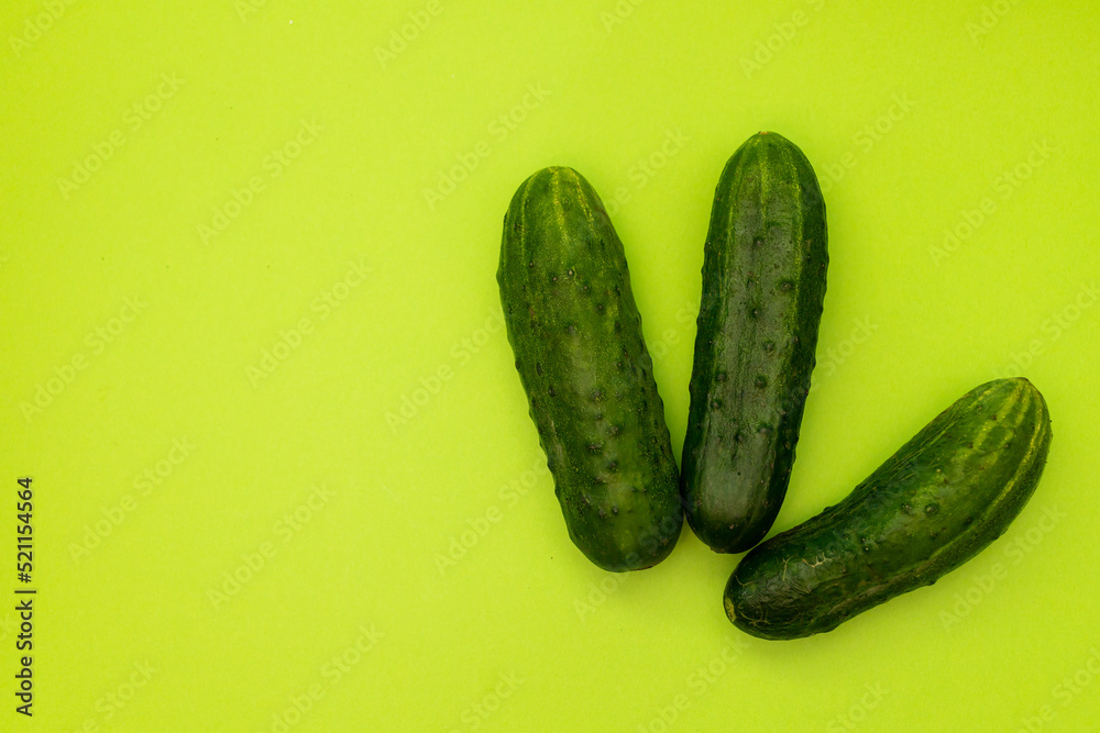 Cucumbers on a green background, monochrome Cucumbers on a green background, monochrome