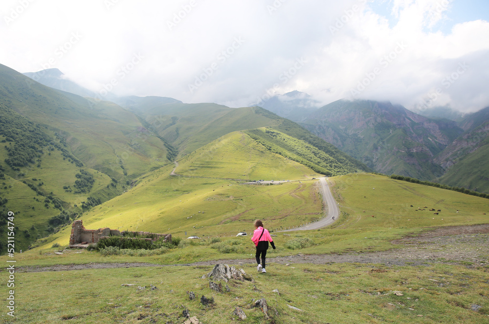 Fototapeta premium Toddler climbs a high mountain