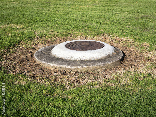 Pipeline manhole with iron cover lid.