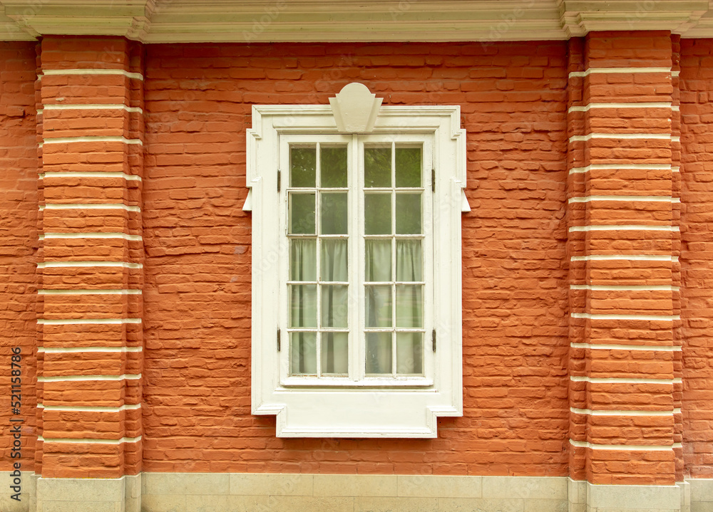 Window in the wall of a brick house.