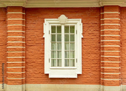 Window in the wall of a brick house. © schankz