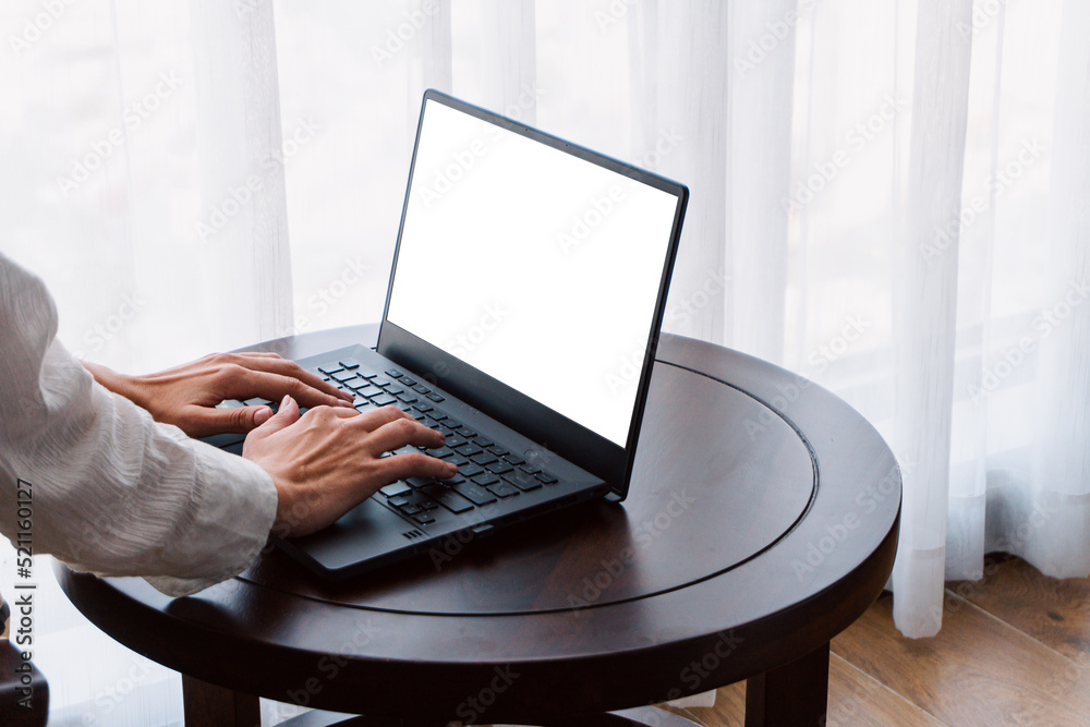 Man working on a laptop, hands close-up, remote work, photo on a light background, project management.