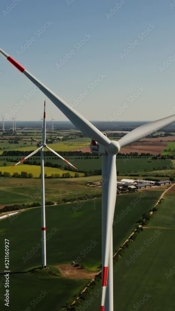 A drone shot of a massive wind farm in agricultural land A drone shot of a massive wind farm in agricultural land