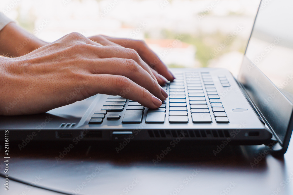 A woman working on a laptop, closeup of her hands and keyboard, the blank screen in the form of a clean template, businesswomen in the office on a light background.