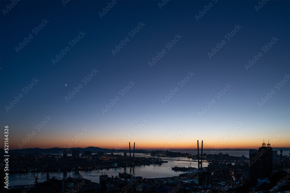 Crescent moon and venus in the dark evening sky.