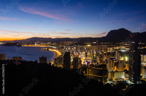 Benidorm, Costa Blanca, Spain at sunset in summer time with a few clouds