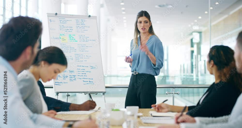 Young executive businesswoman talking in conference meeting of presentation, in formal boardroom of colleagues at modern corporate office. Group of professional business people in marketing training