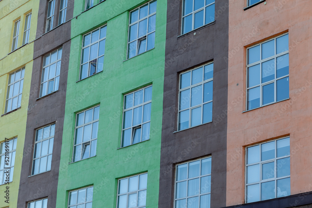 The exterior of a tall building with windows. A newly built building for offices and housing. The exterior of a tall building with windows. A newly built building for offices and housing.