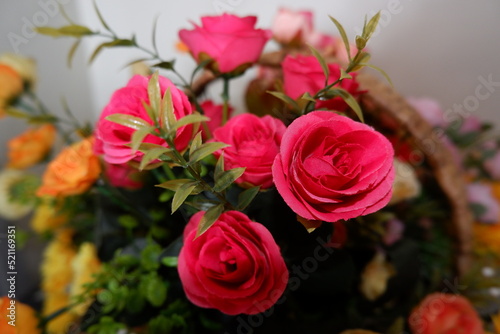 bouquet of red roses fake flowers composition macro  flowers decoration ornamental background  made from fabric and plastic