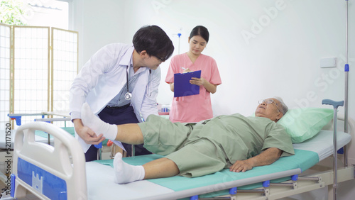 Old elderly Asian patient or pensioner  a nurse and a doctor smiling  doing exercise  working out  in nursing home in hospital.Senior people lifestyle activity recreation. Health care physical therapy
