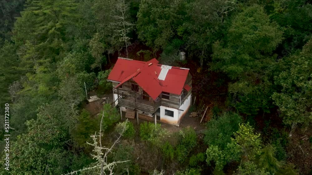 Isolated alone old house in the middle of green tree forest background and in the woods on the mountains surrounded nature. Isolated alone old house in the middle of green tree forest background and in the woods on the mountains surrounded nature.