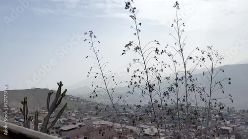 Shanty town slum city over mountain range in Manchay, Lima, Peru. Roadside moving view