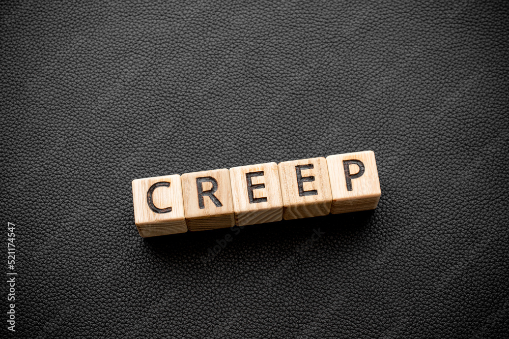 Creep word from wooden blocks with letters, Creep crawl slither