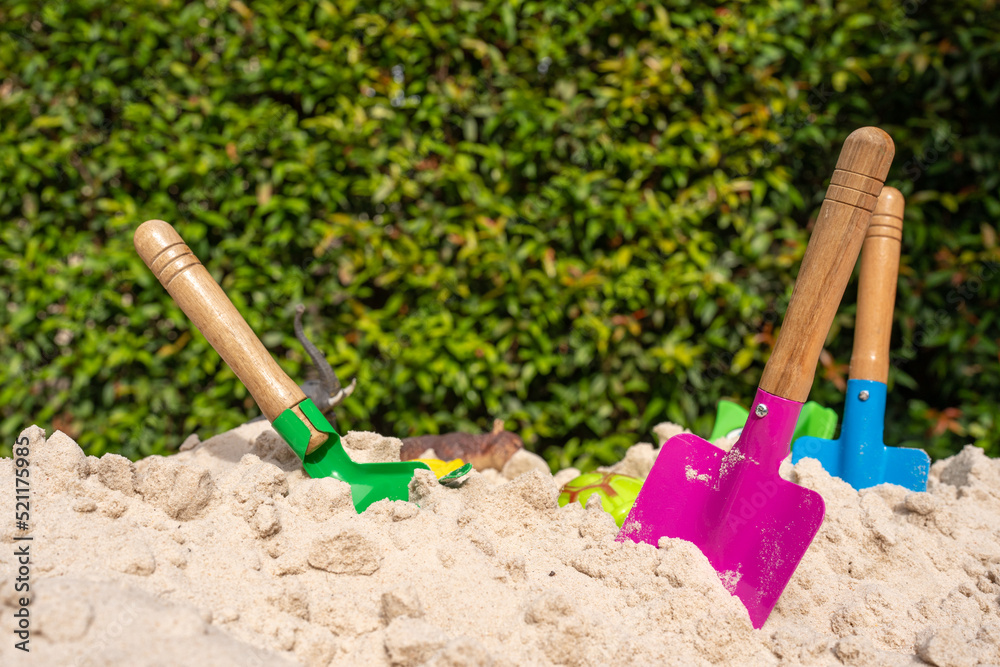 Beach toys in sand pit against nature background. Beach toys in sand pit against nature background.