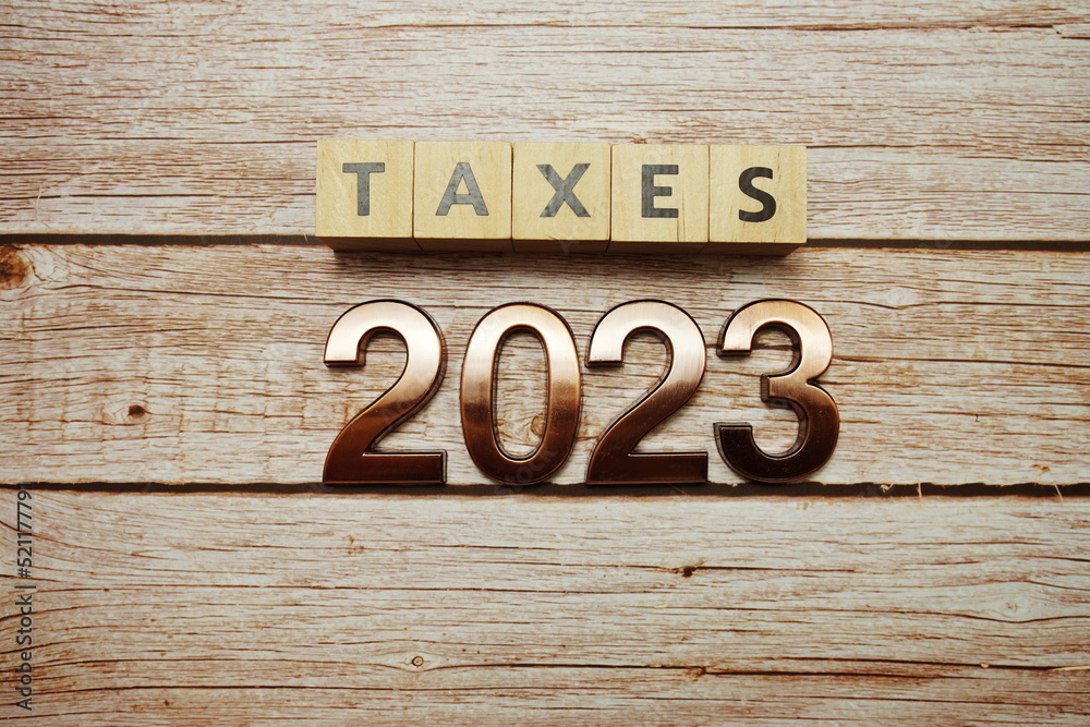 Taxes 2023 alphabet letter on wooden background Taxes 2023 alphabet letter on wooden background