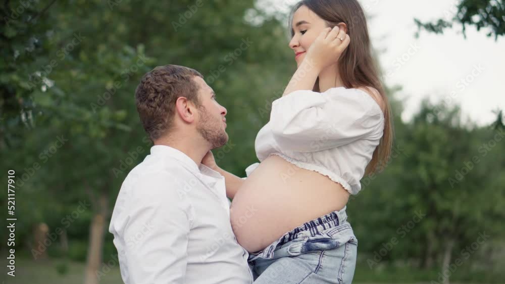 Future mother and father are expecting the birth of a baby, their first child. Beautiful pregnant woman and her husband hugging her tummy. Pregnancy and happiness of a young family. Future mother and father are expecting the birth of a baby, their first child. Beautiful pregnant woman and her husband hugging her tummy. Pregnancy and happiness of a young family.