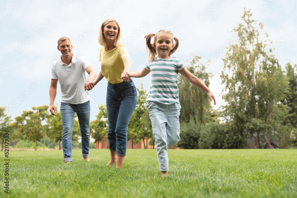 Happy family running in park on summer day Happy family running in park on summer day