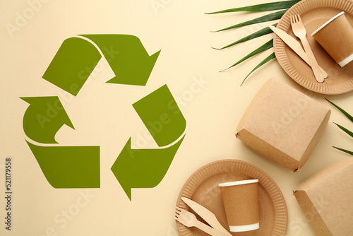 Flat lay composition with eco friendly products and recycling symbol on beige background