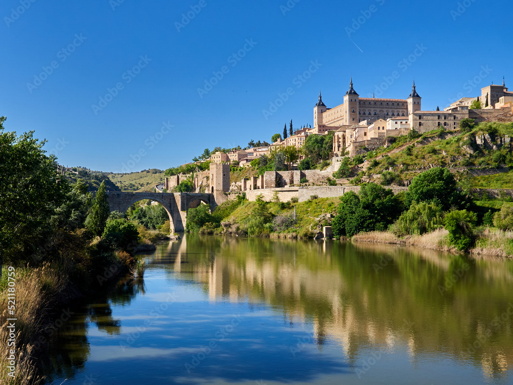 Panoramic view of Toledo with Alcantara bridge over Tagus river, the city wall and the Alcazar. Castilla La Mancha,  Spain, Europe