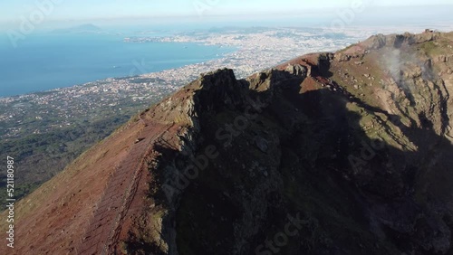 Wallpaper Mural Aerial view of volcano Mount Vesuvius, rough volcanic terrain inside crater on top of mountain - panorama of Naples from above, Italy, Europe. Epic reveal. Drone footage 4K. Cloud over volcano. Torontodigital.ca