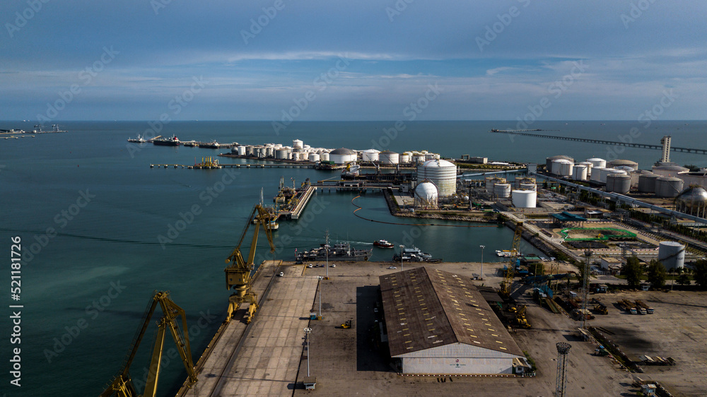 Aerial view oil terminal industrial facility storage oil and petrochemical products for transport to further storage facilities, Storage tank petroleum petrochemical refinery product at oil terminal.