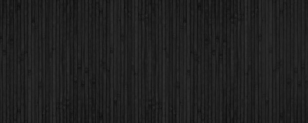 Black bamboo slat wide texture. Abstract wooden backdrop. Textured wood plank dark background