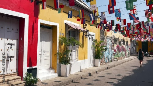 Cartagena - Colombia - View of girl walking in a colorful street full of flags