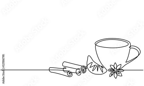 Cup of tea with lemon, cinnamon, anise. Cup of autumn, winter hot spicy tea. Cinnamon tea in glass cup and cinnamon stick. Hot christmas beverage