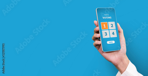 Hand holding smart phone with online voting on screen. election vote concept .