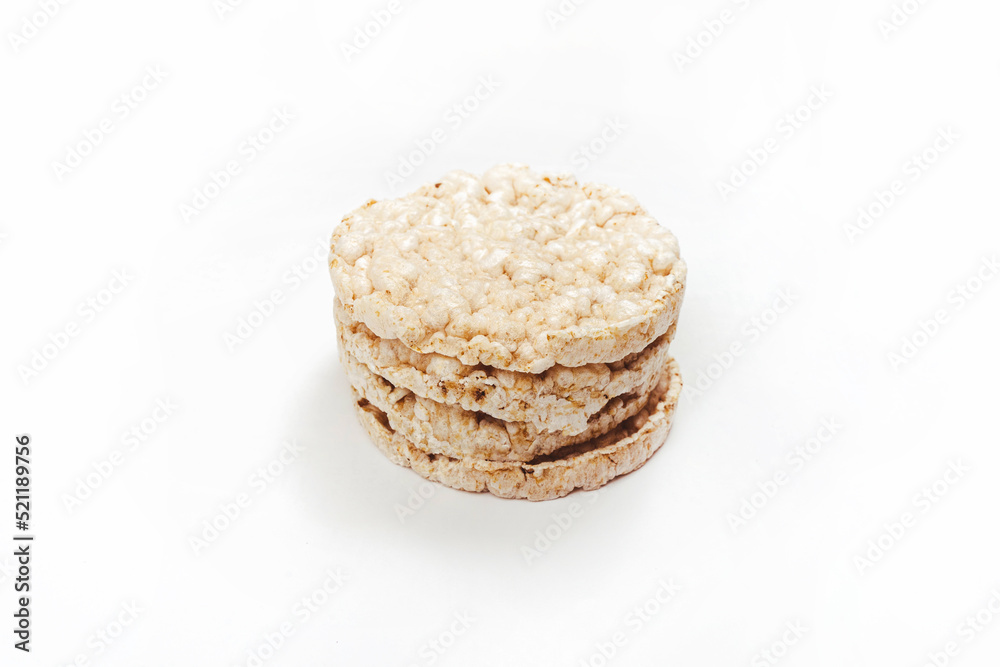 Exquisite stack of round rice crackers on a white surface. Copy Space. Healthy eating.
