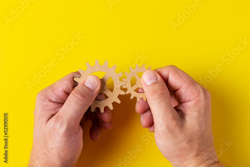 Фотография A person tries to assemble two different gears