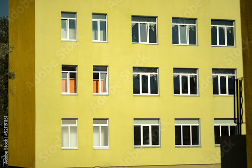 bright school building kindergarten green yellow school background windows minimalism in Ukraine  in Kyiv