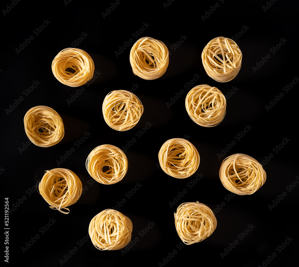 Pasta, spaghetti on a black background top view flat lay. Pasta, spaghetti on a black background top view flat lay.
