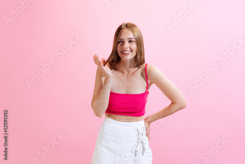 Portrait of young charming girl  student posing isolated on pink background. Concept of beauty  art  fashion  human emotions and facial expressions