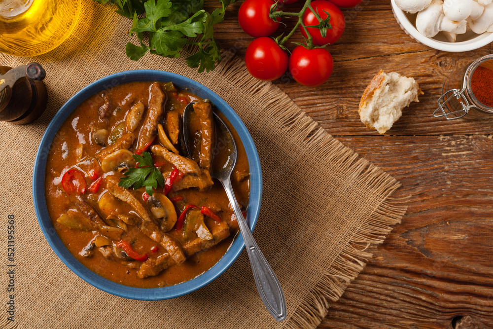 Boeuf, Stroganow, Strogonow. Classic, Russian beef stew. Served in a blue bowl. Top view. Natural background. Boeuf, Stroganow, Strogonow. Classic, Russian beef stew. Served in a blue bowl. Top view. Natural background.