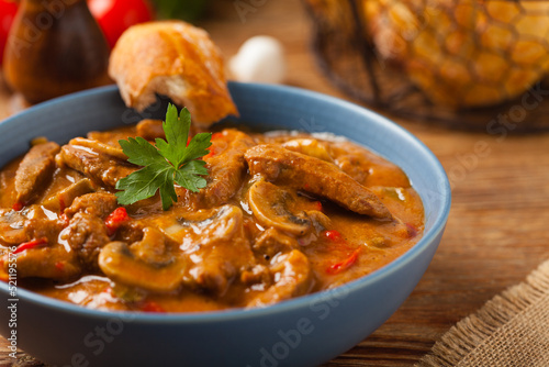 Boeuf, Stroganow, Strogonow. Classic, Russian beef stew.  Served in a blue bowl. Front view. Natural background.