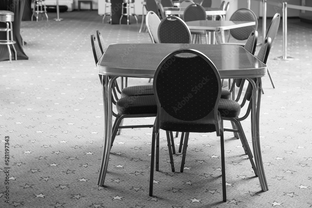 chairs and tables of a cafe in a city