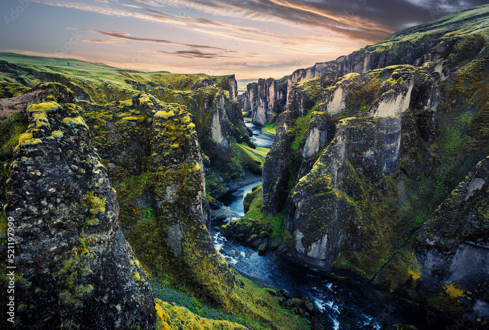 Impressively beautiful nature of Iceland. Canyon Fjadrargljufur  is one famous natural landmark and travel destination place. Tipical Icelandic scenery during sunset. Dramatic Scenery of Iceland.