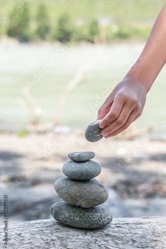 Photography Girl hand picking up set zen stones, relaxed hobby restoring
