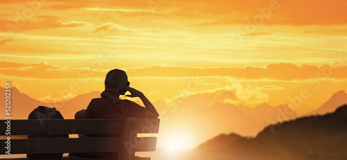 a woman relaxing in nature at the sunset.