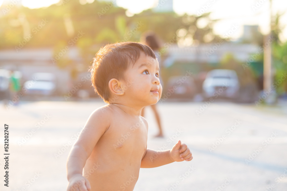 Toddler 2 year asian boy playing outdoor activity and running sunset light Toddler 2 year asian boy playing outdoor activity and running sunset light
